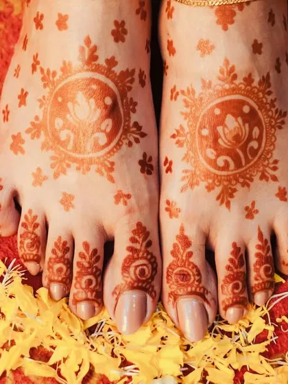 A close-up of the bride's feet, adorned with beautiful mehendi, a detail we love to capture.