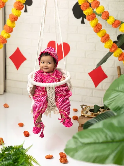 A wider view of the Raja Parba setup, showing the festive marigold and card-suit decorations.
