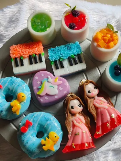 A beautiful collection of some of my most popular return gift soaps, including dolls, pianos, fruit cups, and donuts.