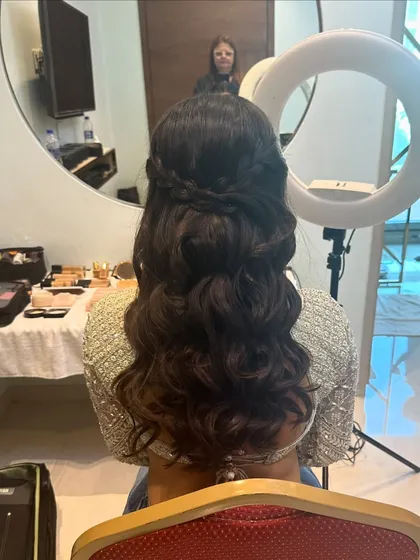 A behind-the-scenes look at this hairstyle. The soft waves are created first, then gathered into a simple, elegant half-up twist.