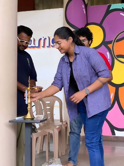 A volunteer lights the inaugural lamp at Sign Fest, symbolizing the start of a bright and hopeful event focused on community and communication.