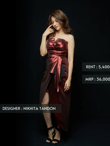 This metallic red cocktail dress by Nikhita Tandon is designed for a glamorous night out. The strapless, draped silhouette is both bold and sophisticated, offered at a fraction of its original price.