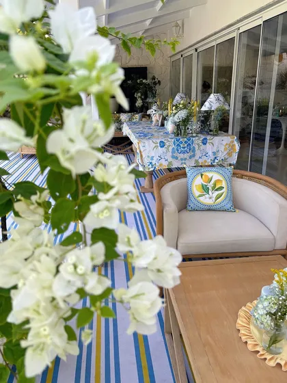 A serene view of the outdoor party setup, with white bougainvillea framing the shot.