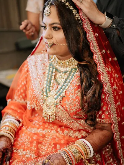 A behind-the-scenes shot during the Sangeet look creation. Even while getting ready, her skin looks radiant, thanks to thorough skin prep before any makeup is applied.