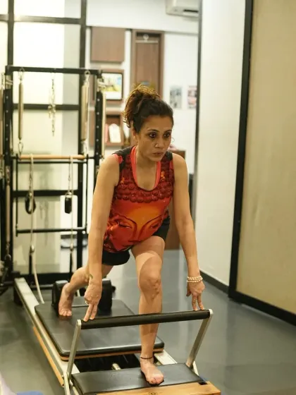 A client holds a lunge on the reformer, demonstrating focus and grace. Pilates strength is balanced and controlled, creating a body that is as resilient as it is strong.