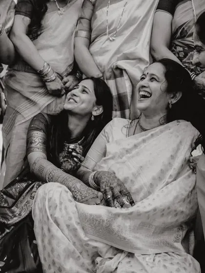 A candid shot of a bride sharing a laugh with her mother during the festivities. The joy in their faces is just beautiful.