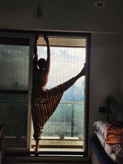 My teaching has evolved to focus on simple, effective practices. This pose, a supported standing split, reflects the idea that yoga is about how it feels, not just how it looks.