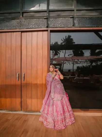 A beautiful bridal portrait at a beachside resort in Goa. The reflection of the palm trees in the glass doors adds a lovely tropical touch to this elegant shot.