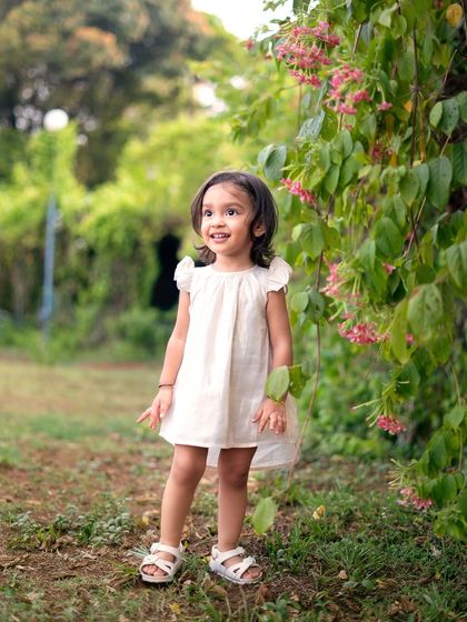 A beautiful portrait in the garden. After the messy fun of painting, we took some time to capture her sweet smile in a clean white dress.