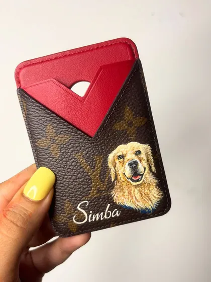 I absolutely love painting pet portraits. There's something so special about capturing your furry friend's personality. This custom Louis Vuitton card holder features a hand-painted portrait of a happy Golden Retriever named Simba, making it a truly personal keepsake.