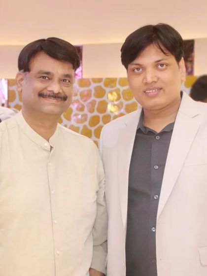 Two guests posing for a photo together during a family function.