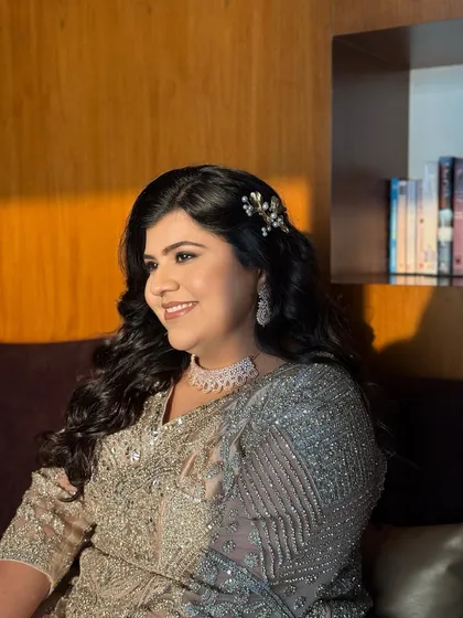 A candid, happy moment. Her makeup looks flawless and glowing in the warm light.