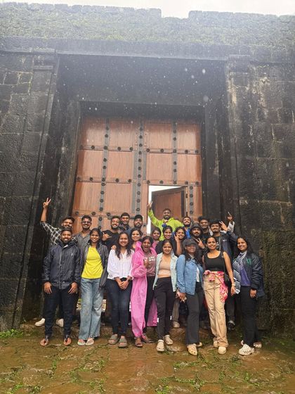 A group photo in front of the massive gates of a fort near Kodachadri.