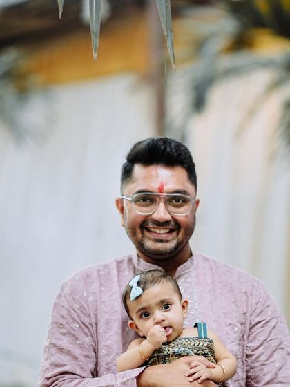 A proud father holds his daughter during her birthday celebration. These father-daughter moments are precious, and we ensure they are captured with warmth and affection.