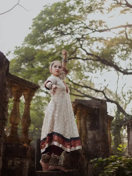 A dramatic pose set against old stone ruins. The dancer's upward reach and the historic setting create a timeless portrait that blends art, history, and nature.