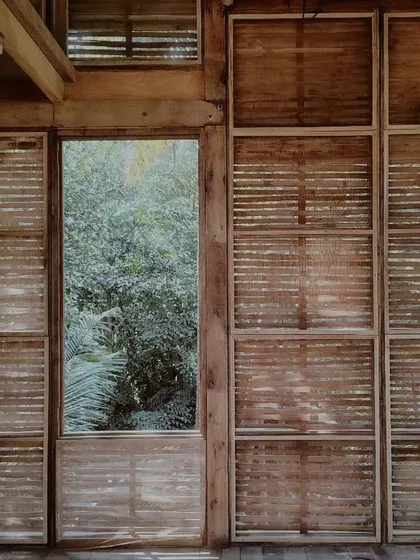 A detail of the cottage's interior walls, showing the woven bamboo lath that forms the base for the earthen plaster.