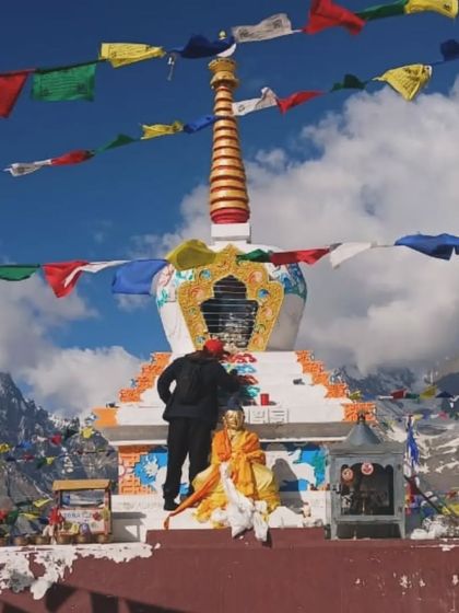 A wider shot of the Stupa painting project. The vibrant prayer flags and snow-capped mountains created an incredible backdrop for making art.