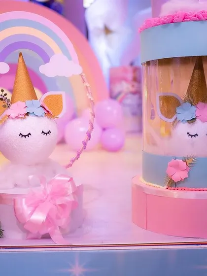 Adorable unicorn-themed decor pieces. The smaller unicorn head is made from a styrofoam base, and the larger one is a custom-made return gift holder.