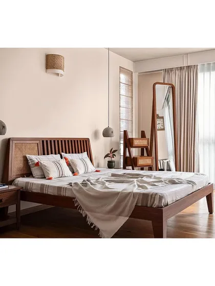 In this master bedroom, I focused on creating a warm, sophisticated retreat. The bed, with its teak veneer and rattan details, is the centerpiece. I designed a custom ladder storage unit that doubles as a unique decor element. The interplay of wood, rattan, and concrete textures results in a balanced and inviting environment.
