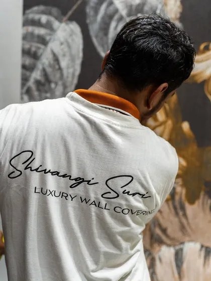 Our trusted installer, part of the Shivangi Suri team, carefully works on a large floral mural. We handle every aspect of the installation to ensure a flawless finish for your luxury wallcoverings.
