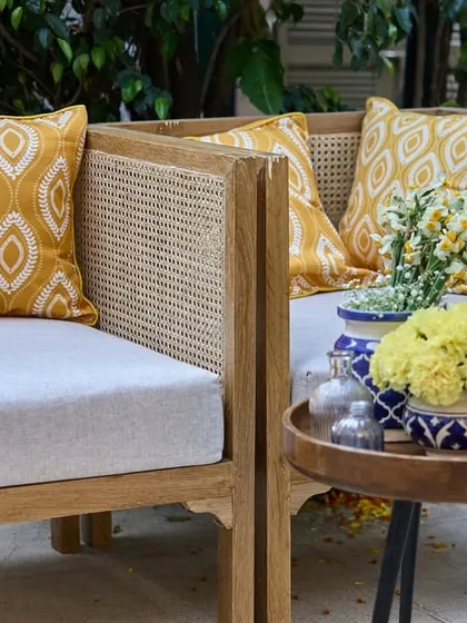 Another angle of the chic lounge seating, showing the mix of patterned cushions and the simple, elegant floral arrangement.
