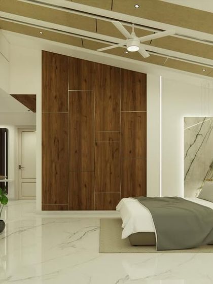 The master bedroom in "Yash Villa" features a sloped ceiling with wooden rafters and a dramatic marble-clad wall behind the bed.