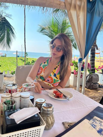 Waiting for my order at a beach shack in Goa. A colourful halter top is my go-to for a vibrant, beachy vibe.