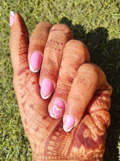A sweet and pretty design for a wedding event. I used a bright pink gel polish with a white French tip outlined in gold glitter. The hand-painted heart on the accent nail makes it extra special.