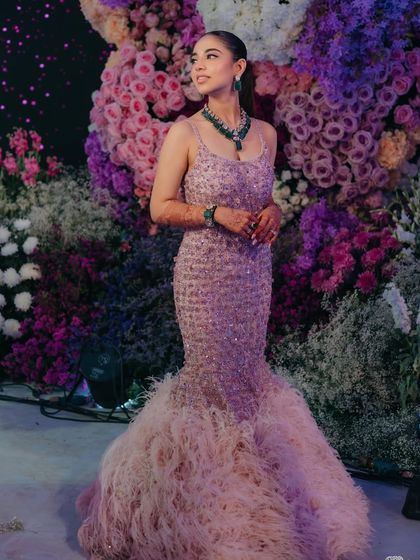 A full-length view of the bride's incredible feathered gown. The entire look is a showstopper.