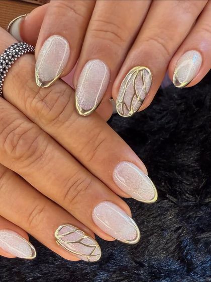 This elegant design features a shimmery white base with delicate gold chrome outlines. An accent nail with a butterfly wing pattern adds a touch of artistic flair.