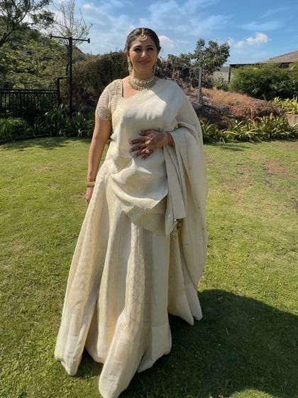 The full look is one of understated elegance. The ivory outfit is timeless, and the makeup is kept soft and natural to match.