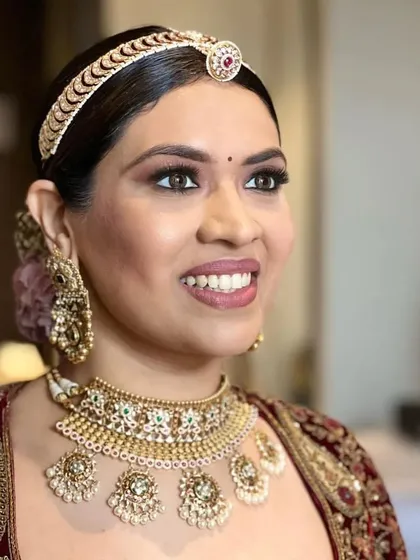 A portrait of a bride with a traditional floral bun, a timeless choice for any wedding ceremony. The hairstyle is both elegant and secure.