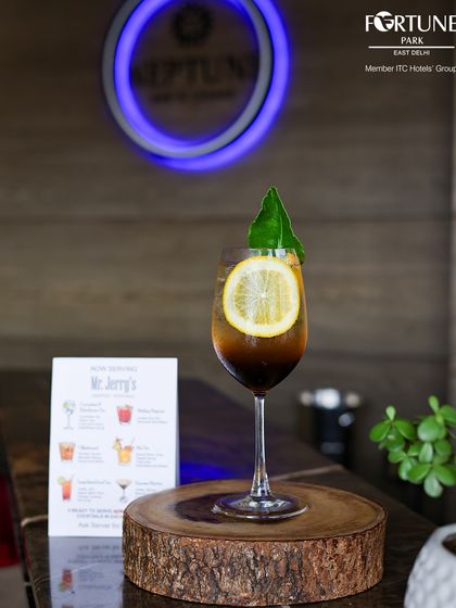 A signature cocktail from our menu, presented on a rustic wooden slice, showcasing our creative presentation.