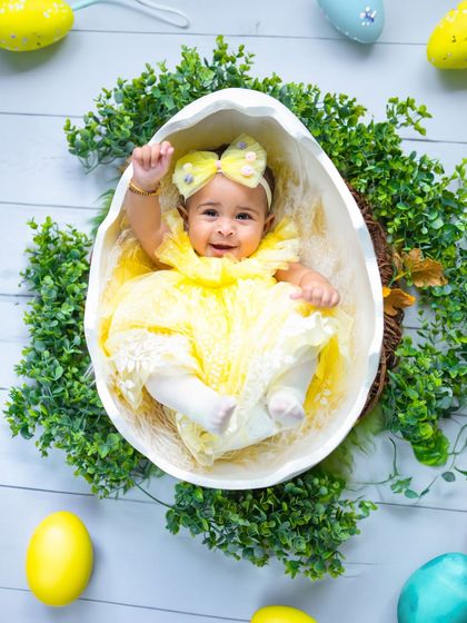 Waving hello from inside an eggshell! This playful pose captures the fun and whimsy of our Easter and spring-themed sessions.
