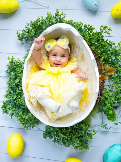 A happy wave from inside the egg. I love capturing these playful and interactive moments during our themed sessions.