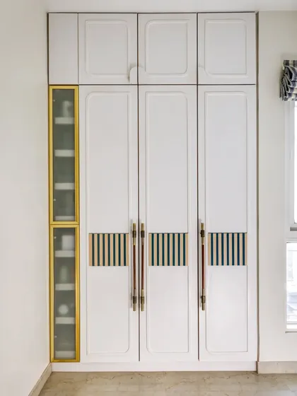 The full view of the custom wardrobe, with its clean lines, unique handles, and integrated accessory storage.