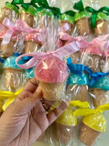 A colorful array of my handmade ice cream cone soaps, each tied with a ribbon and ready for gifting.