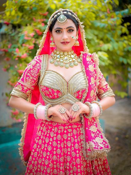 A lovely portrait capturing a traditional pose. The focus is sharp on the bride, making her stand out against the soft floral background.