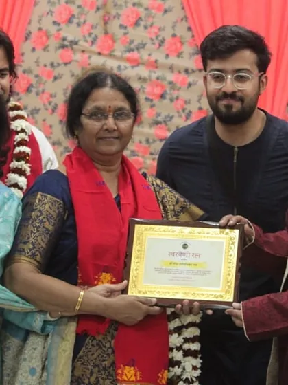 A group of artists on stage during the felicitation ceremony.