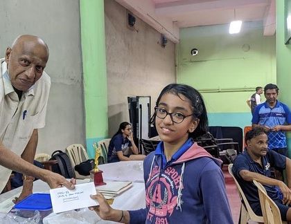 Himanshi receiving her award at the Mission Olympics 2028 event.