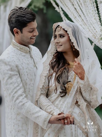 An intimate Nikah ceremony at Farmhouse Collective. The couple shares a look of love, framed by elegant white drapes that complement their beautiful attire.