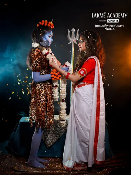 A dynamic shot of Shiva and Parvati during their photoshoot. The falling flowers add a touch of magic and movement to the scene.
