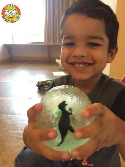 Digging for dinosaurs. This young paleontologist is so excited to have excavated a dinosaur from a giant ice egg.