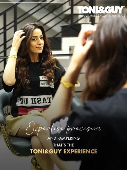 Expertise, precision, and pampering. That's the Toni&Guy experience. This client is admiring her fresh style in the mirror, a moment of pure satisfaction.