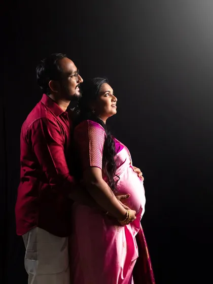 Embracing tradition can be incredibly powerful. In this studio portrait, we used dramatic lighting to highlight the elegance of the saree and the couple's hopeful gaze towards the future. It’s a beautiful blend of cultural heritage and the journey to parenthood.