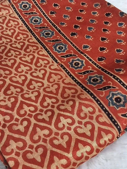 Our fabric collection is where your design ideas begin. This is a beautiful piece of Ajrakh handblock printed modal fabric, with its classic earthy tones and intricate patterns. You can use it to create a custom kurti, a stylish top, or even a beautiful dupatta.