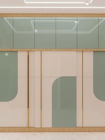 A kids' room with a mint green and white theme, featuring a modern wardrobe with curved-patterned doors.