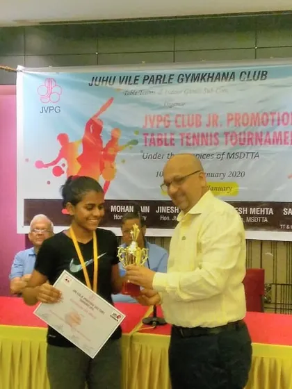 Manasi Jare receiving her winner's trophy at the JVPG promotional tournament. Her smile says it all.