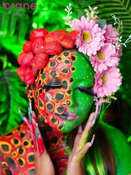 A close-up of the 'Nature's Fury' look, with eyes closed to showcase the detailed texture work and color blending on the eyelids.