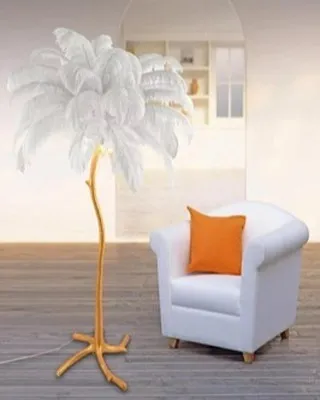 We took inspiration from nature to create this luxury ostrich feather tree lamp. The gold, branch-like base supports a plume of soft white feathers, transforming a floor lamp into a whimsical and glamorous statement piece.
